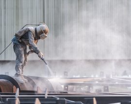Industrial worker while doing an abrasive blast